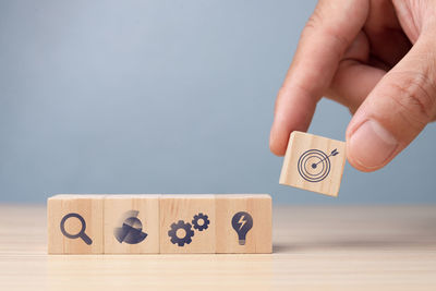 Close-up of hand holding toy blocks on table