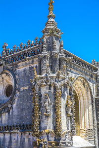 Low angle view of statue against blue sky