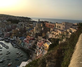 High angle view of townscape by sea against sky