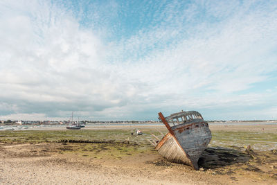 Abandoned boat on the beach of gâvres in brittany in france