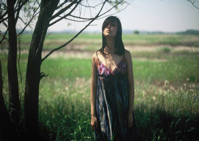 Young woman standing on field