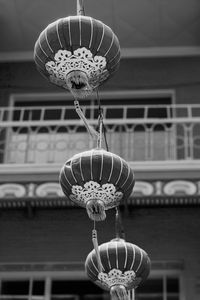 Low angle view of lanterns against building