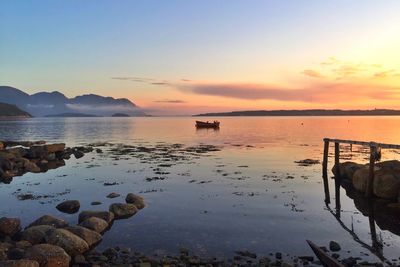 Scenic view of sea against clear sky at sunset