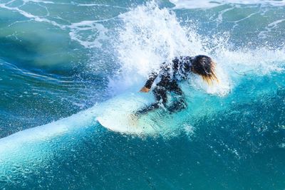 Man splashing water in swimming pool
