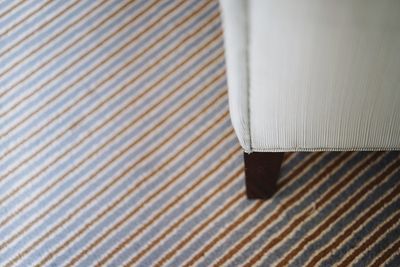 High angle view of chair on rug