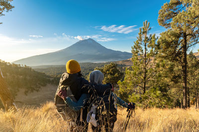 Rear view of couple looking at landscape