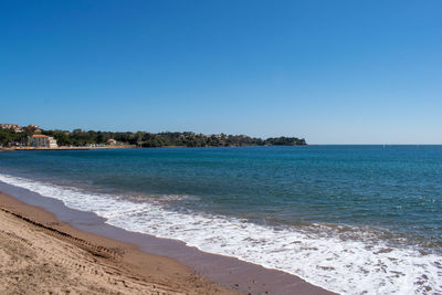 Scenic view of sea against clear blue sky