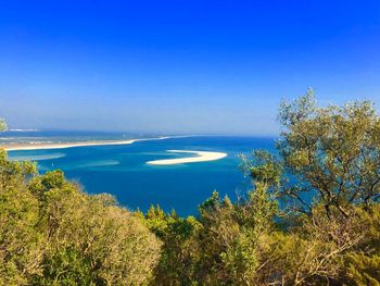 Scenic view of sea against clear blue sky