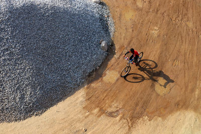 High angle view of man riding bicycle on road