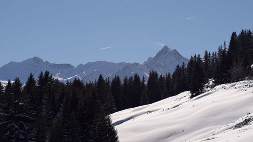 Scenic view of snowcapped mountains against clear sky