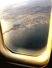 Cropped image of airplane wing over landscape