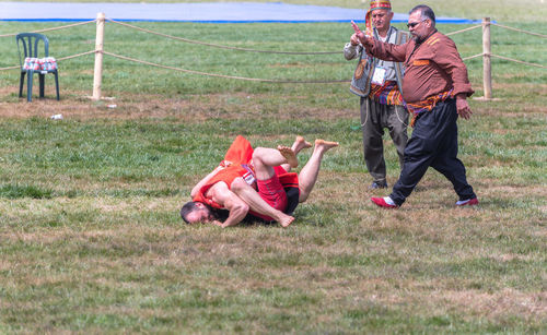 Men playing on field