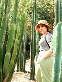 Portrait of girl standing by plants
