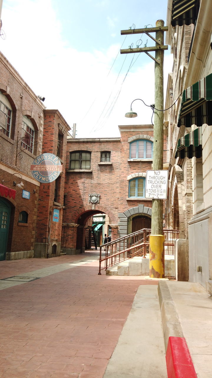 STREET BY BUILDINGS IN CITY AGAINST SKY