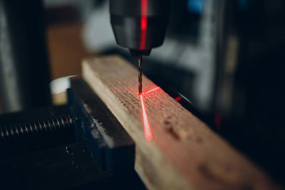 Close-up of machine drilling on wood