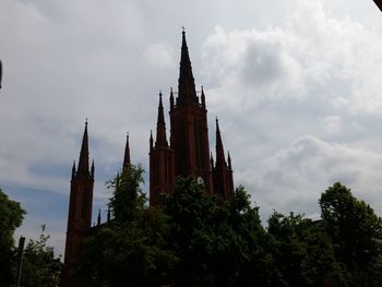 Low angle view of church against cloudy sky