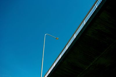 Low angle view of street light against blue sky