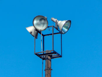 Low angle view of street light against clear blue sky