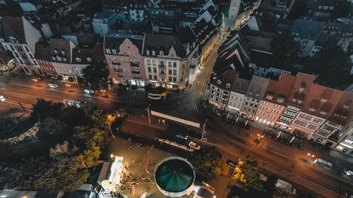 High angle view of illuminated street amidst buildings in city