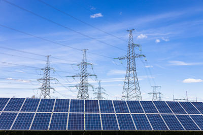 Solar panels, high voltage electricity towers, and transmission power lines