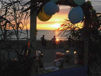 Silhouette of people on beach during sunset