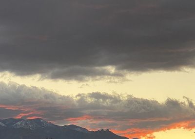 Low angle view of mountains against dramatic sky