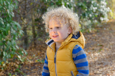 Close-up of smiling boy in forest