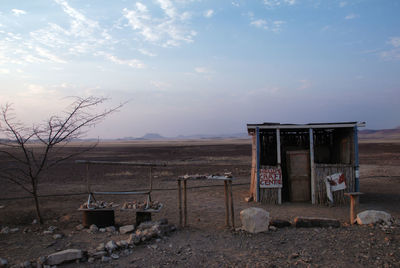 Lifeguard hut on landscape against sky