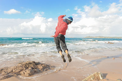 Full length of man on beach against sky