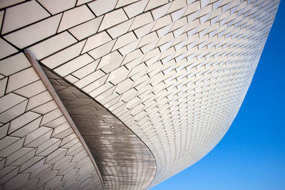 Low angle view of modern building against blue sky