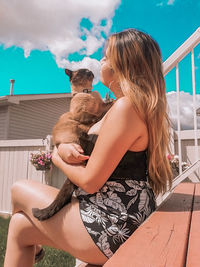 Midsection of woman sitting at home