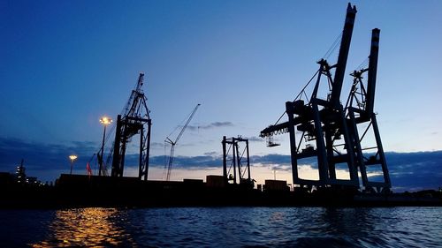 Silhouette of cranes at commercial dock