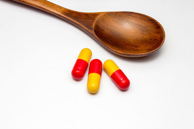 High angle view of multi colored pencils on white background