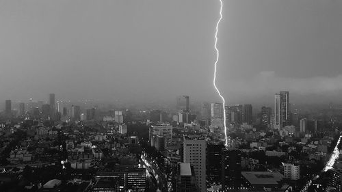 Aerial view of city against sky at night