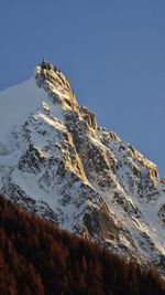 Scenic view of snowcapped mountains against clear blue sky
