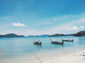 Boats in sea against sky