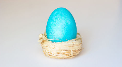 Close-up of blue eggs against white background