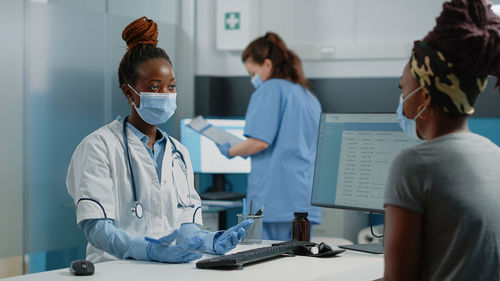 Doctor and nurse examining patient in clinic