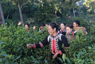 Group of people against plants