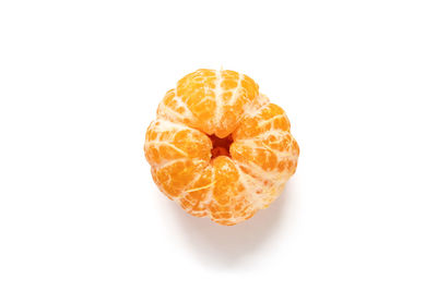 Close-up of orange fruit against white background