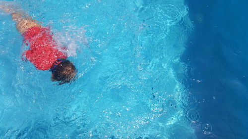 High angle view of boy swimming in pool