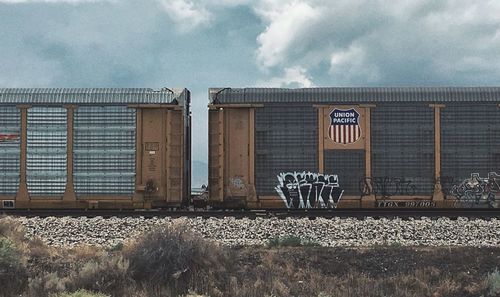 Text on railroad track against sky