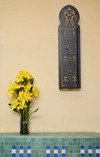 Flower vase against wall of building