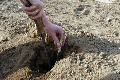 Close-up of hands working on rock