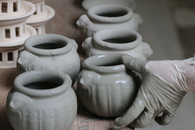Close-up of hand with pottery