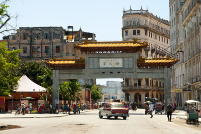 People and car on road in city