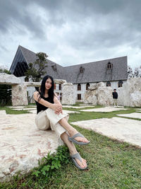 Young woman sitting on field