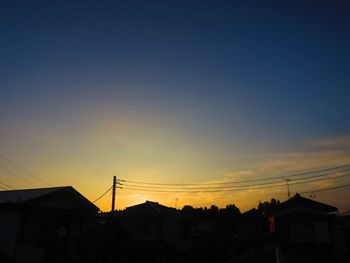 Low angle view of silhouette buildings against sky during sunset