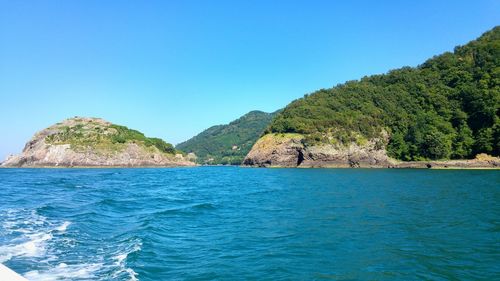 Scenic view of sea against clear blue sky