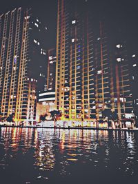 Reflection of illuminated buildings in city at night